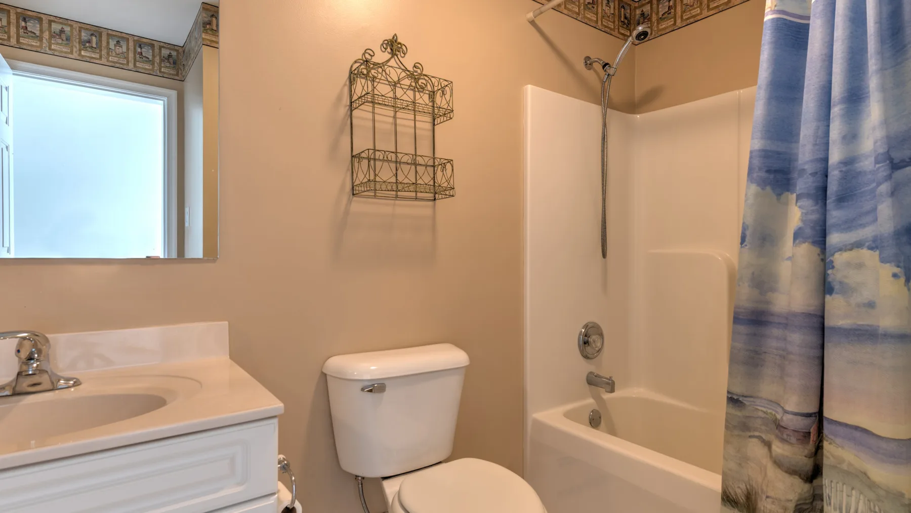 A bathroom with a bathtub, shower, and sink beside a window.