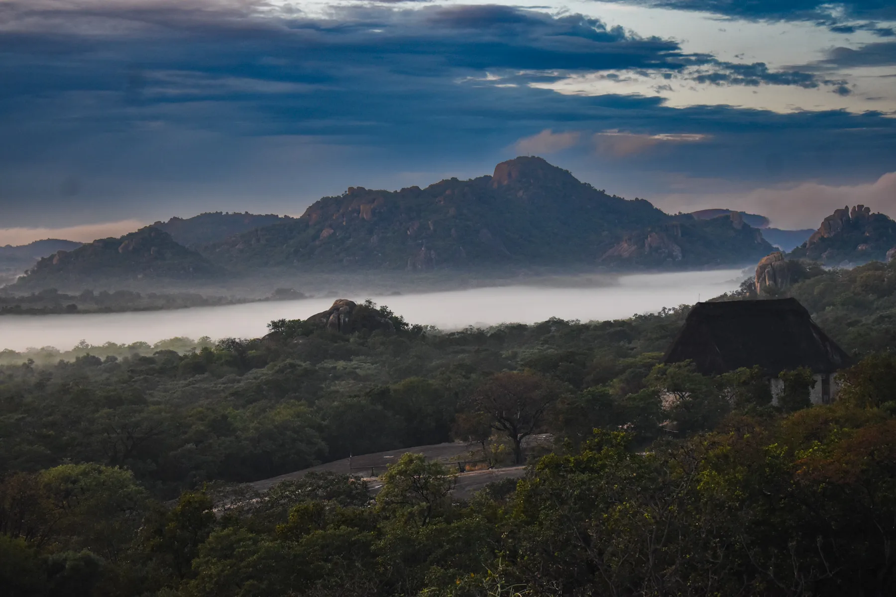 Granite kopjes rising from morning mist