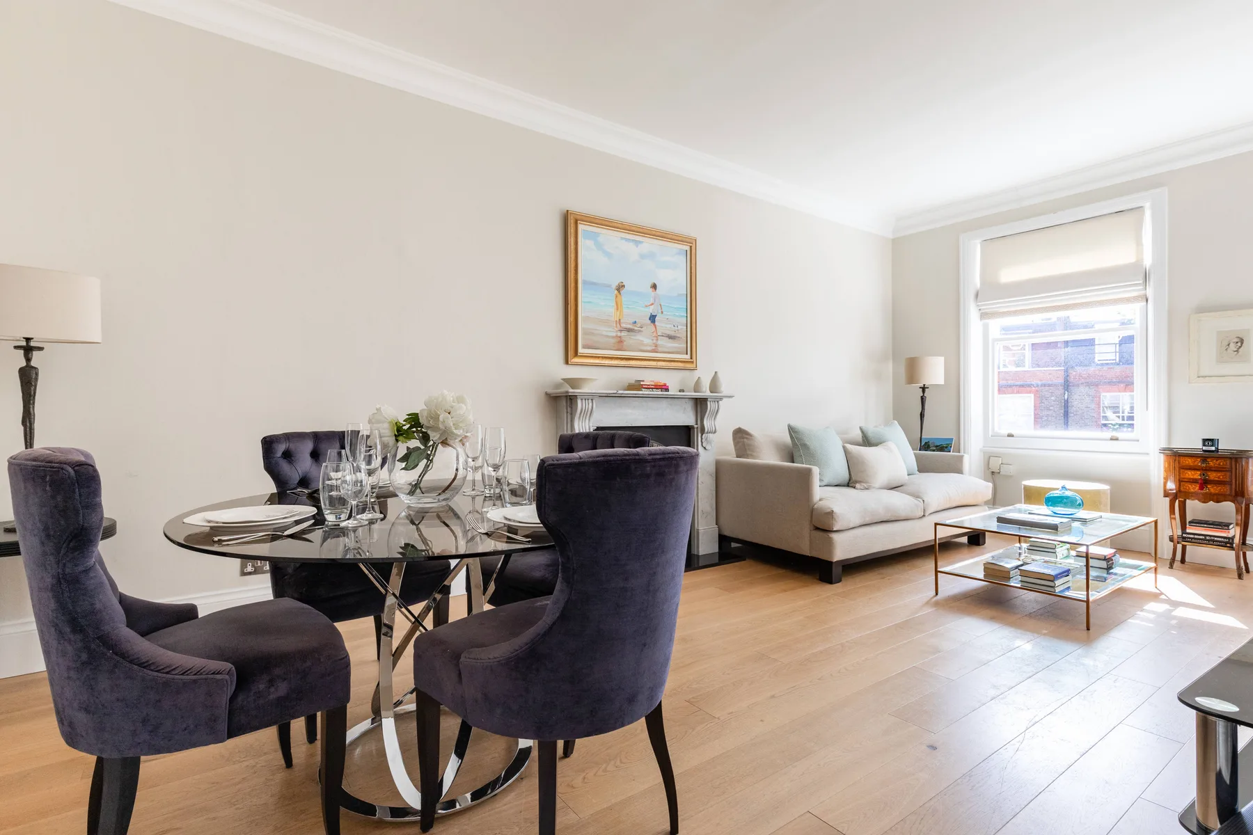A living and dining room with seating arranged around a table and coffee table.