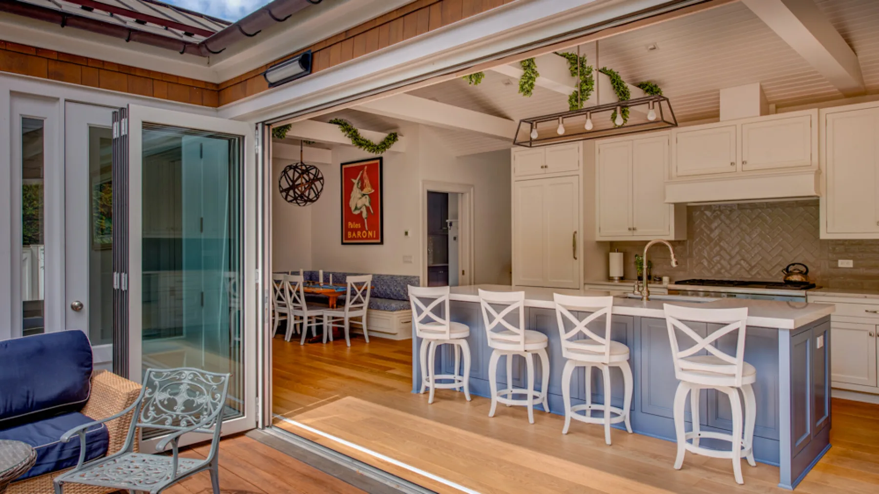 An open-plan kitchen and dining area has a long counter with bar seating.