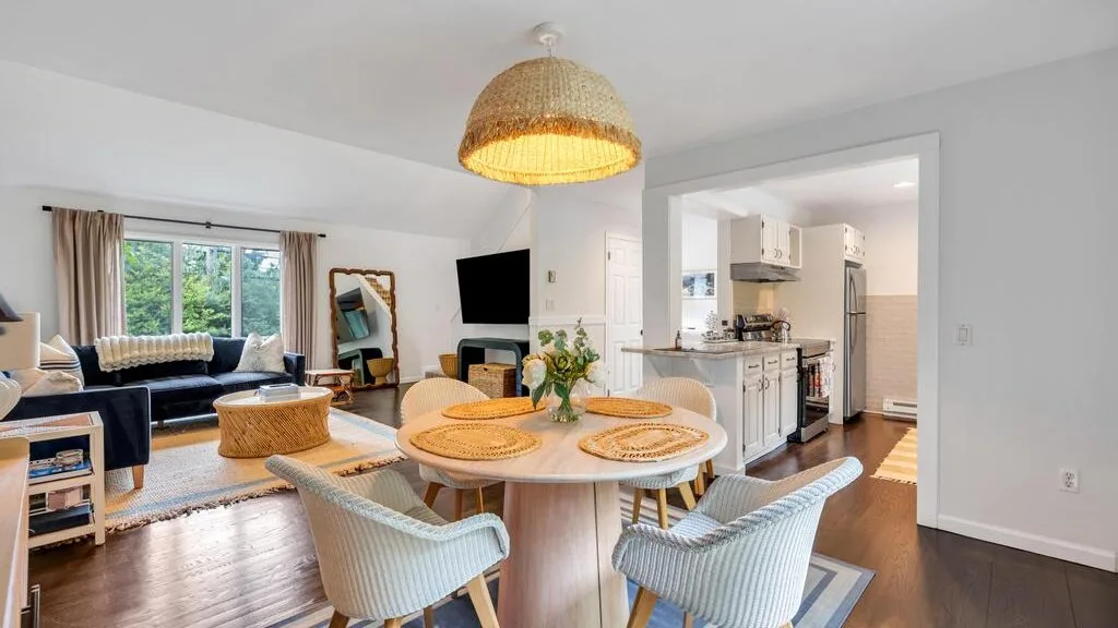 An open-plan living and dining area with a kitchen, dining table, and seating.
