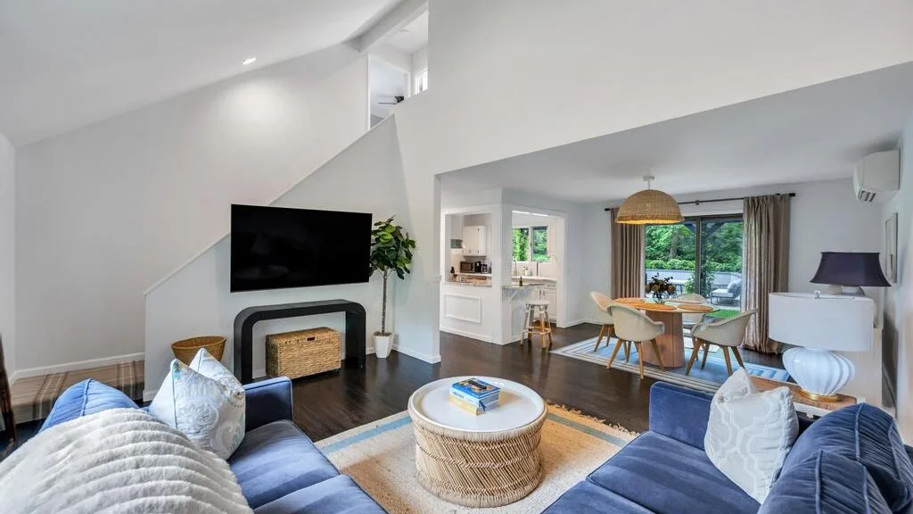Open-plan living and dining room with seating around a coffee table.