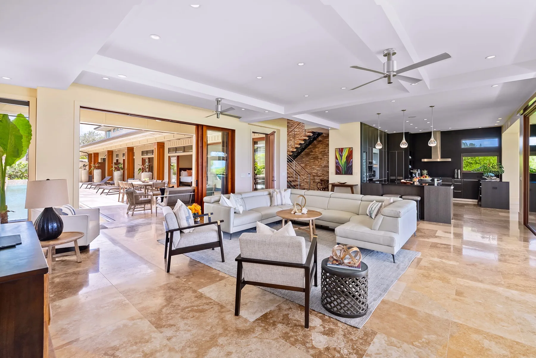 An open-plan living room with a seating area beside the kitchen and dining space.