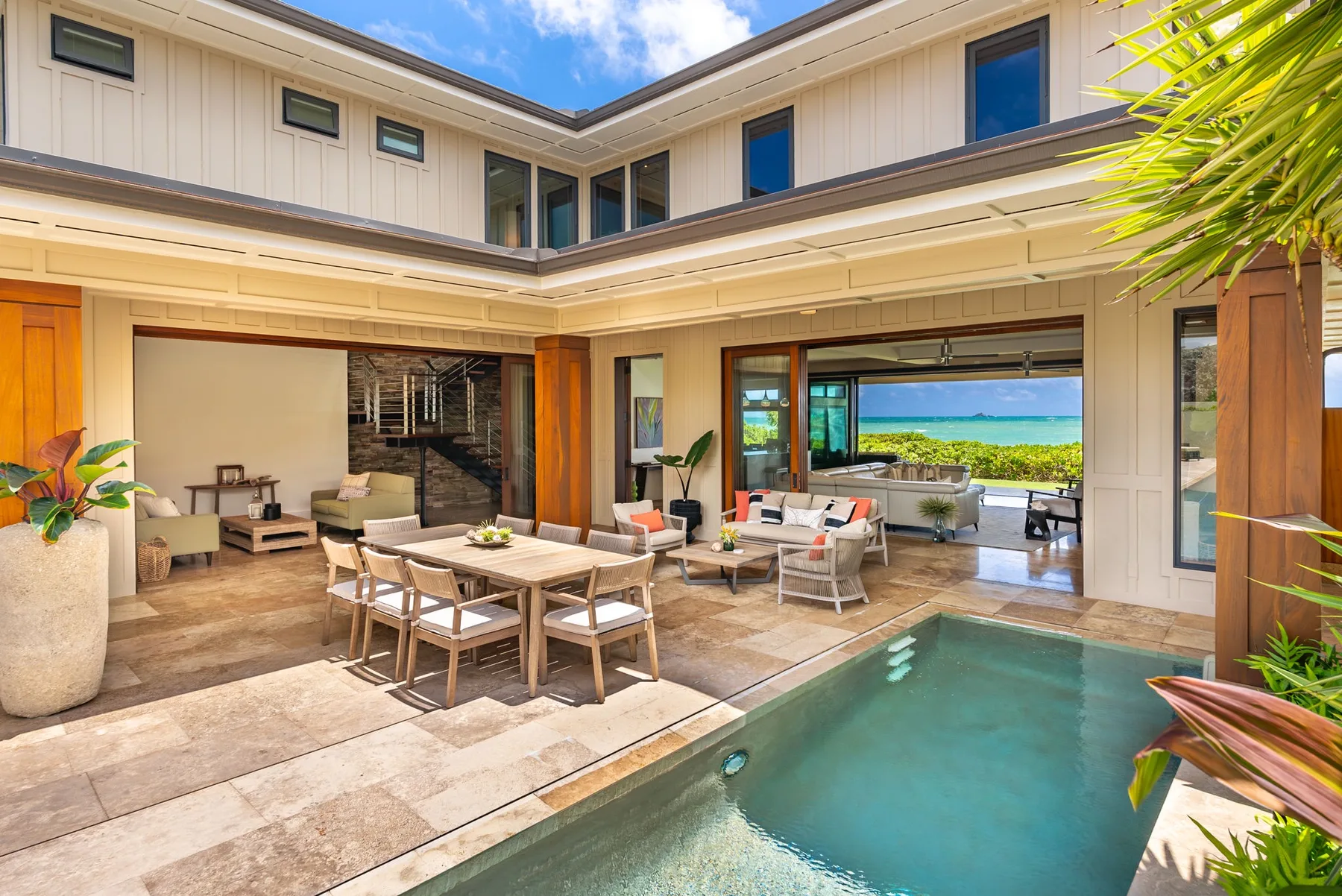 A bright courtyard patio with outdoor seating and a swimming pool.