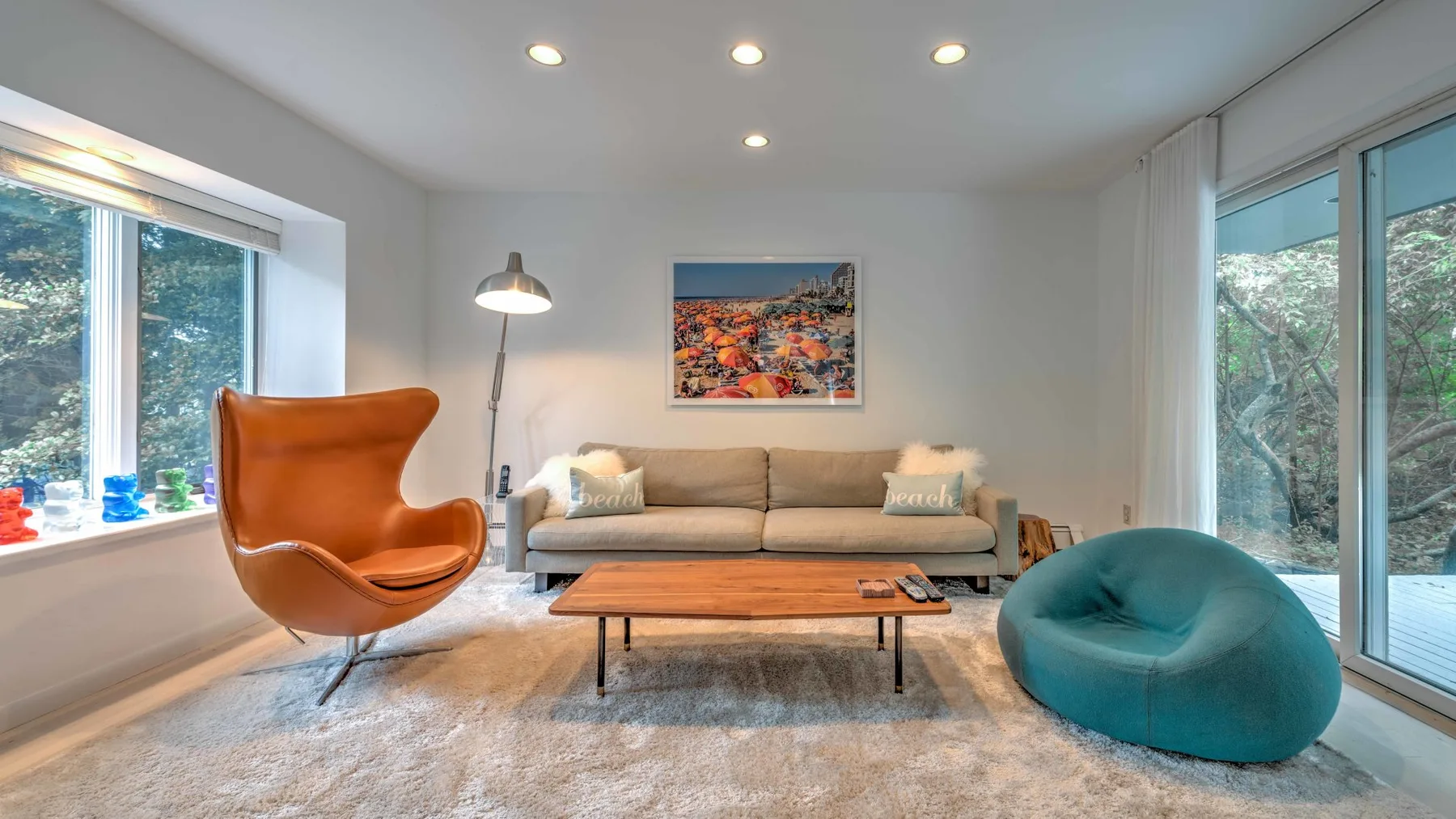 A bright living room with a sofa, a coffee table, and large windows.