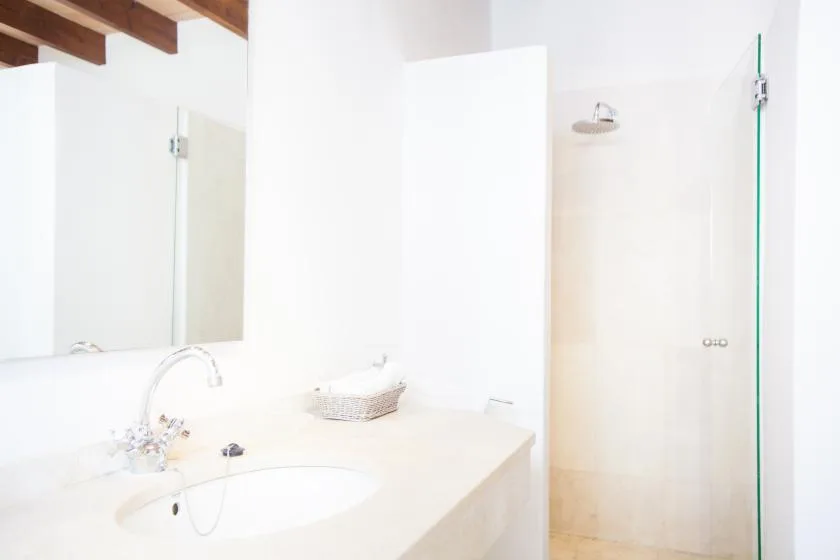 Un baño luminoso con lavabo y ducha.