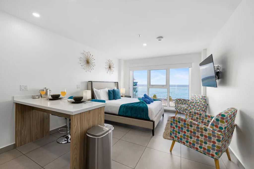 Wake up to stunning ocean views framing your cozy retreat, where fresh mornings begin with breakfast at your intimate counter and endless sea stretches beyond your private balcony.