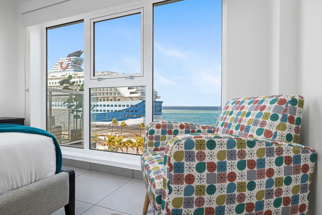 Wake up to cruise ships gliding past your window and brilliant blue sea views framing your cozy retreat—your perfect island escape starts here.