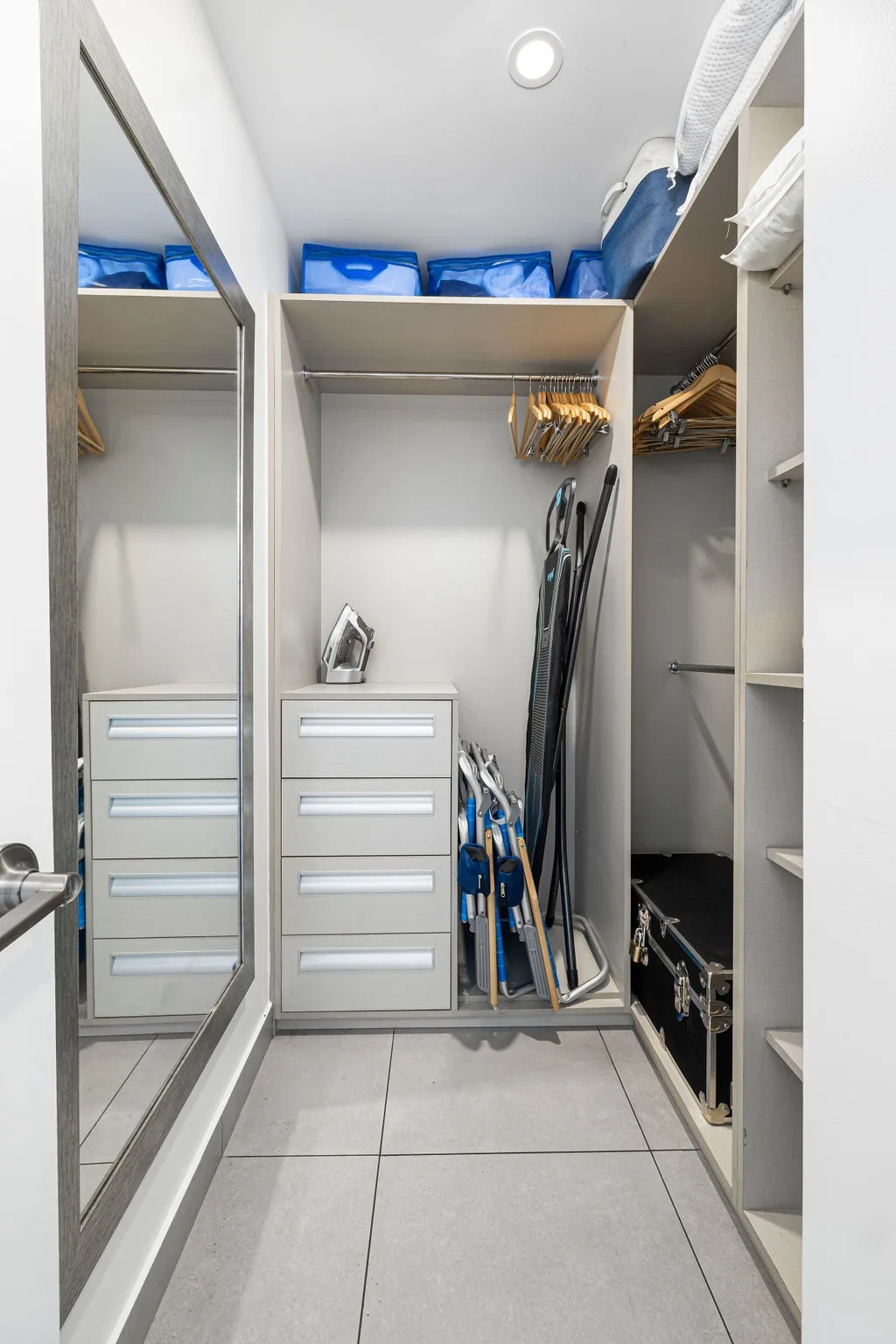 Your private walk-in closet offers ample hanging space, built-in drawers, and organized storage to keep everything neatly in place during your stay.