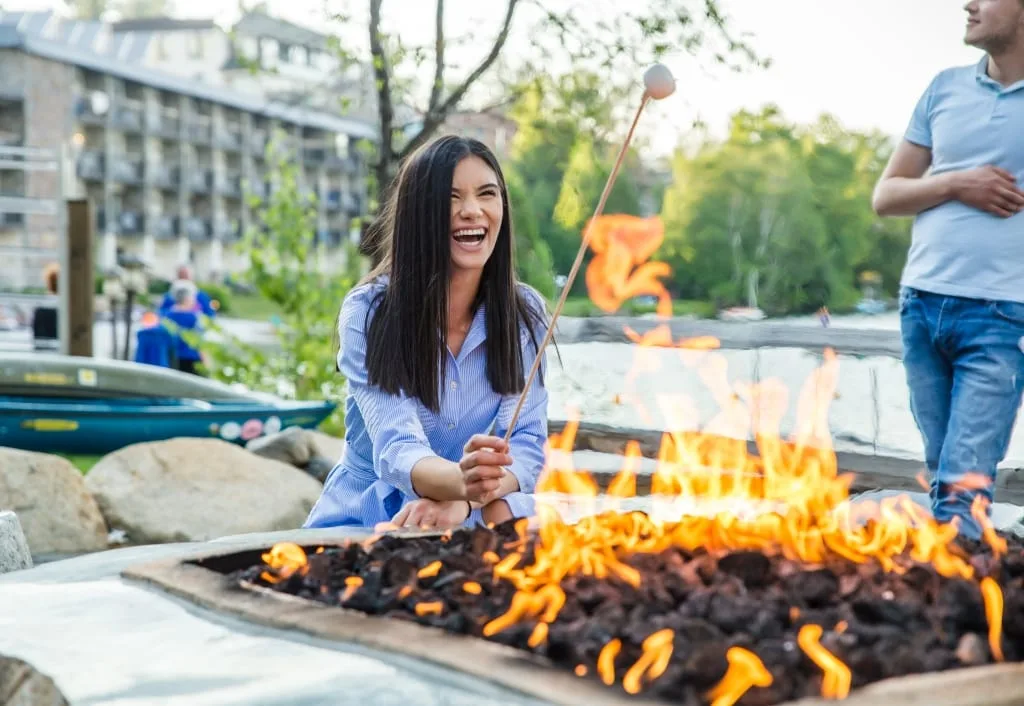 Guest roasting marshmallows at an outdoor firepit
