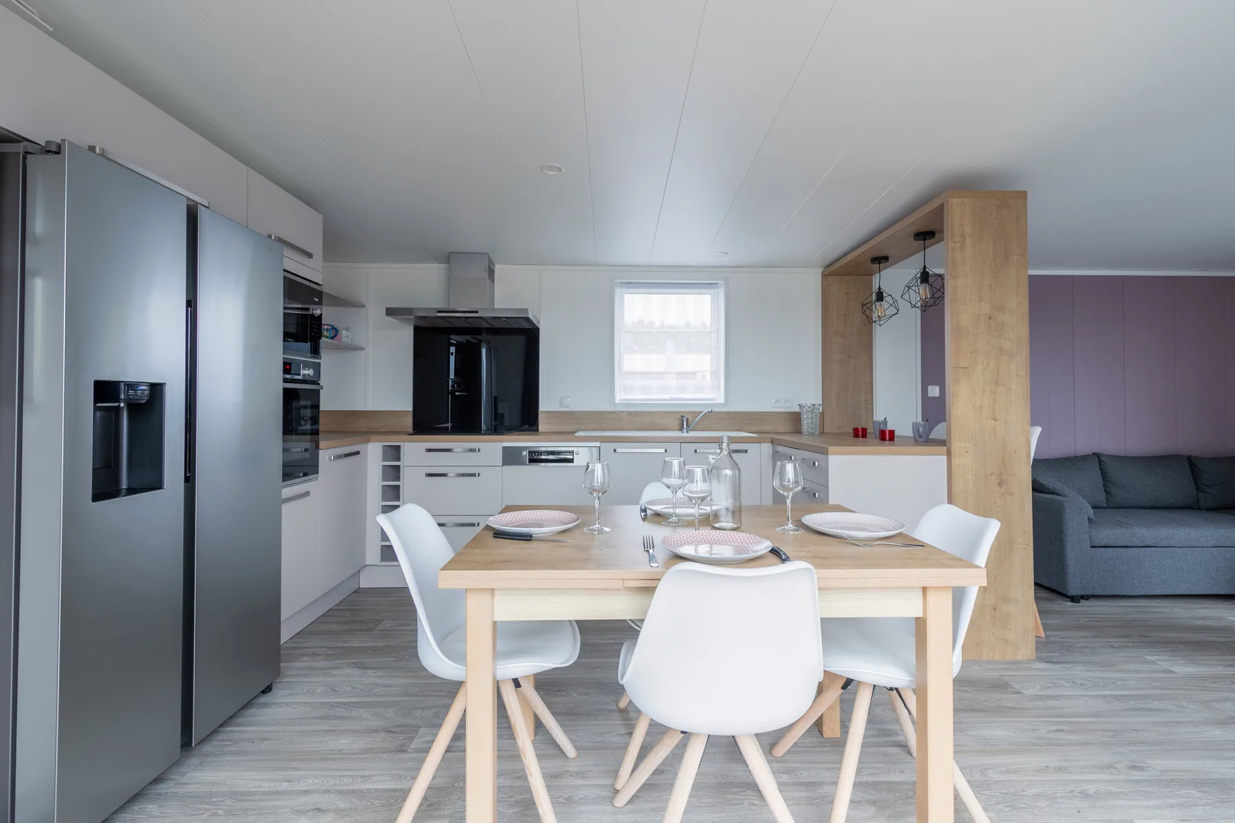 A modern kitchen and dining area with a table and seating.