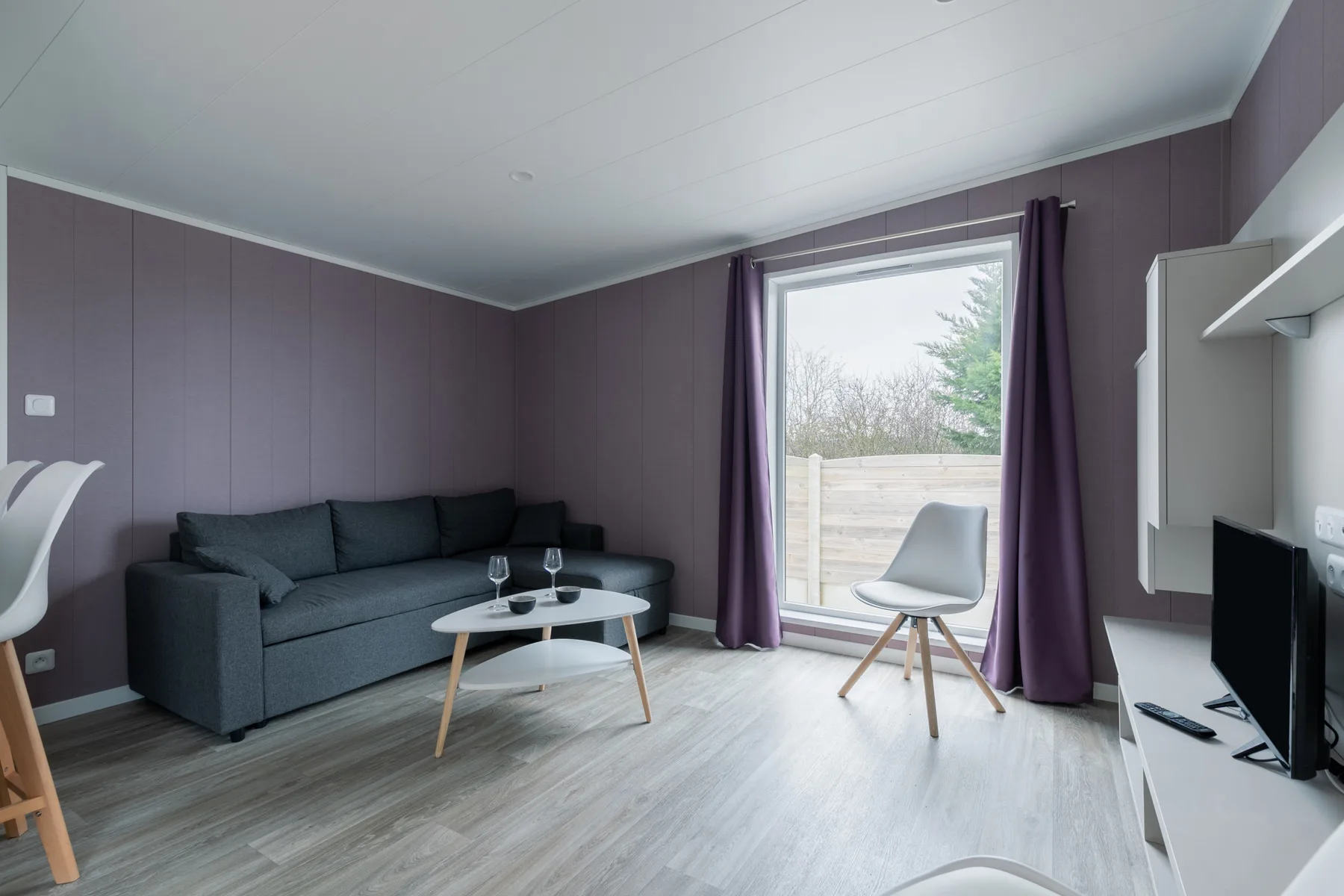 Living room with a gray sofa and a large window.
