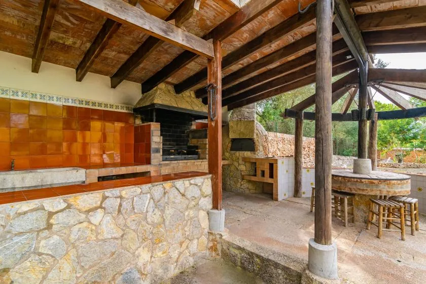 An open-air cooking area with a tiled counter and a built-in oven.