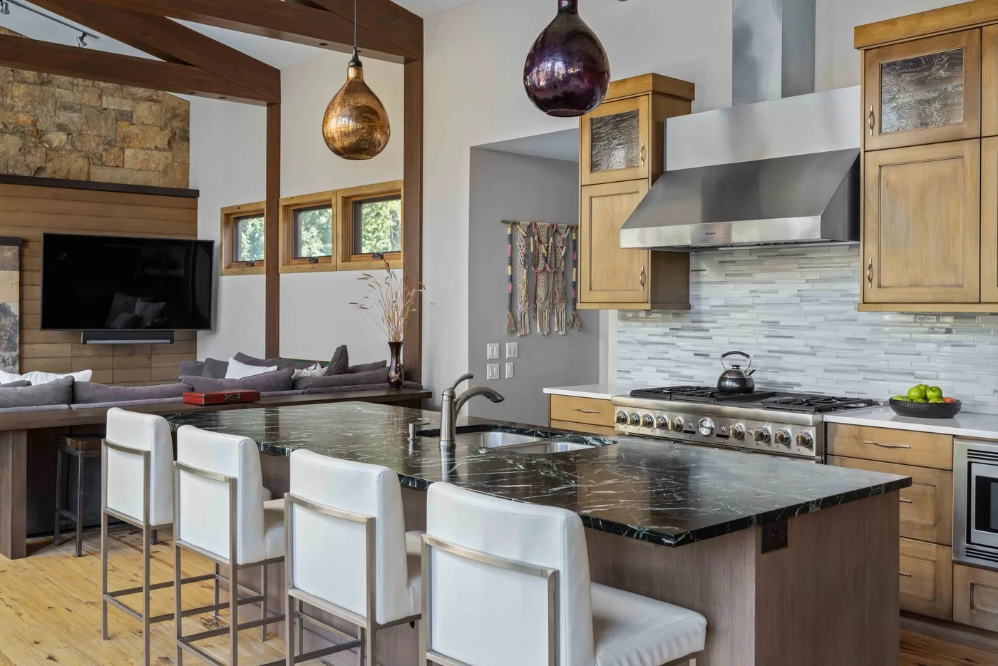 An open-plan kitchen and living area with a large island and counter seating.