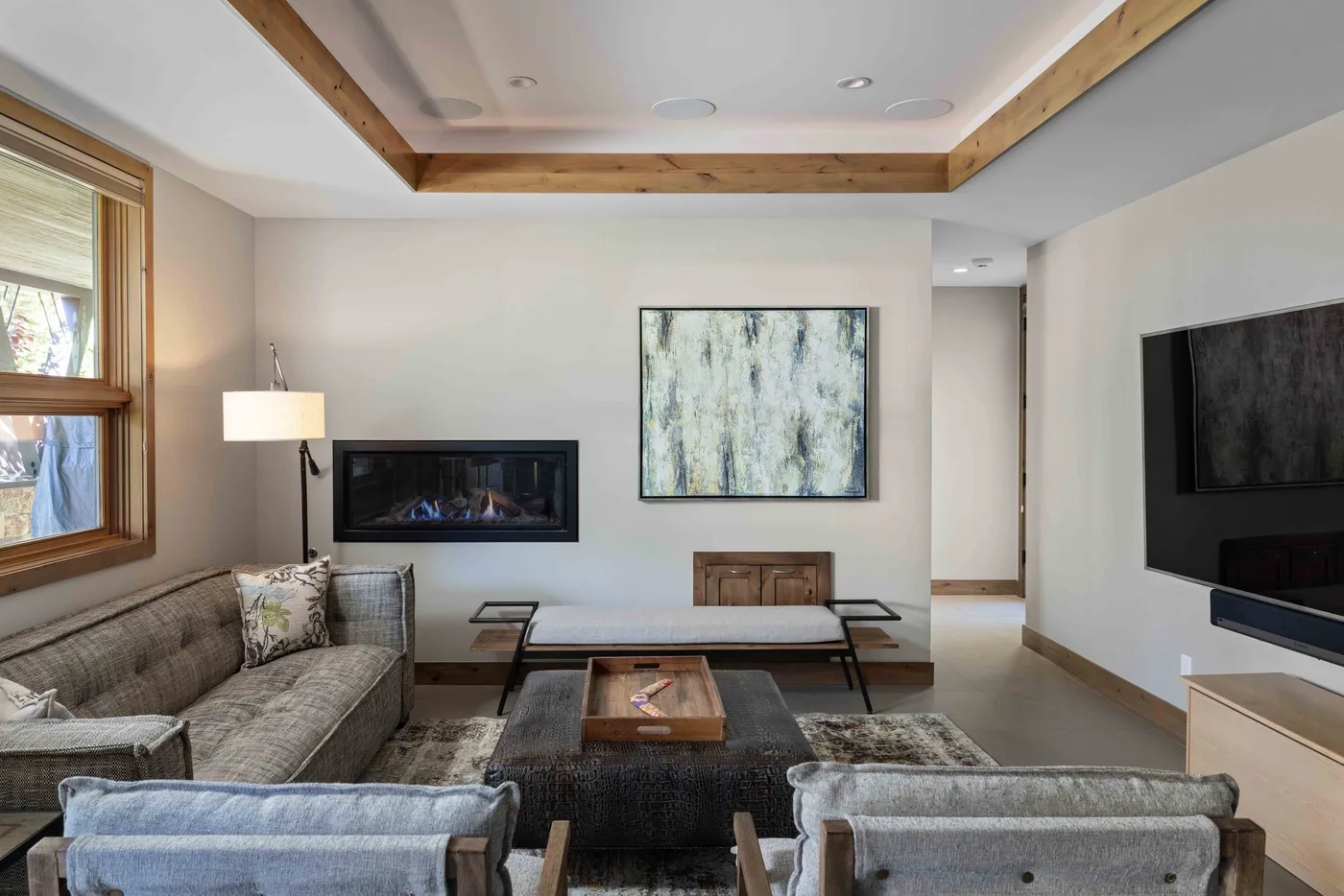 A living room with seating, a fireplace, and a television.