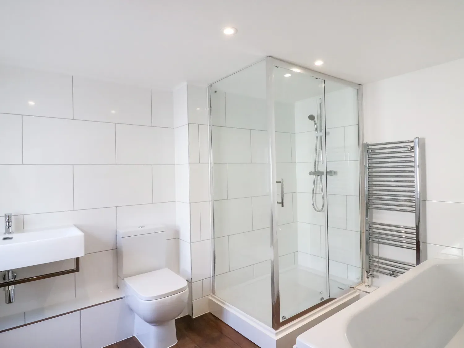 A bathroom with a sink, toilet, shower and bathtub.