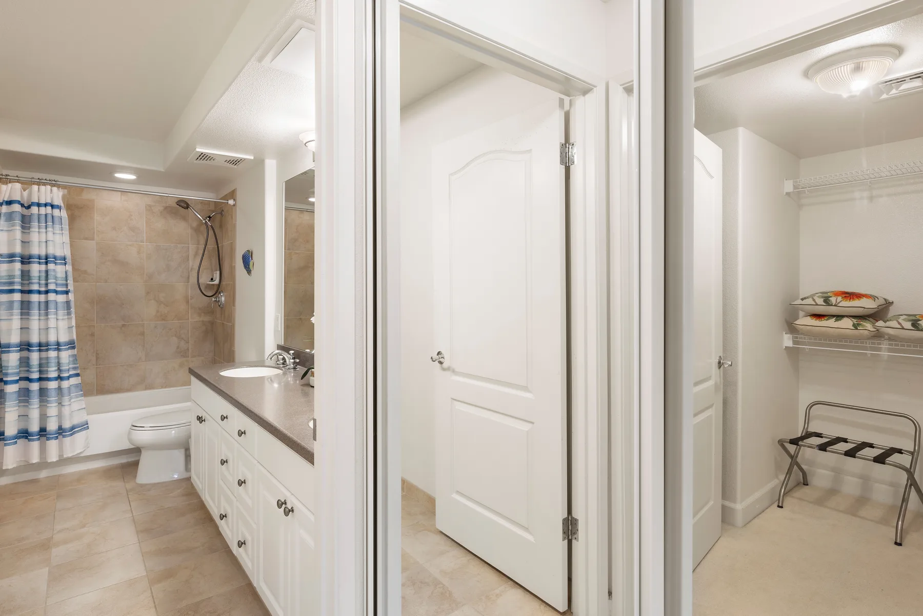 A bathroom with a bathtub and vanity is shown beside a closet with shelves.