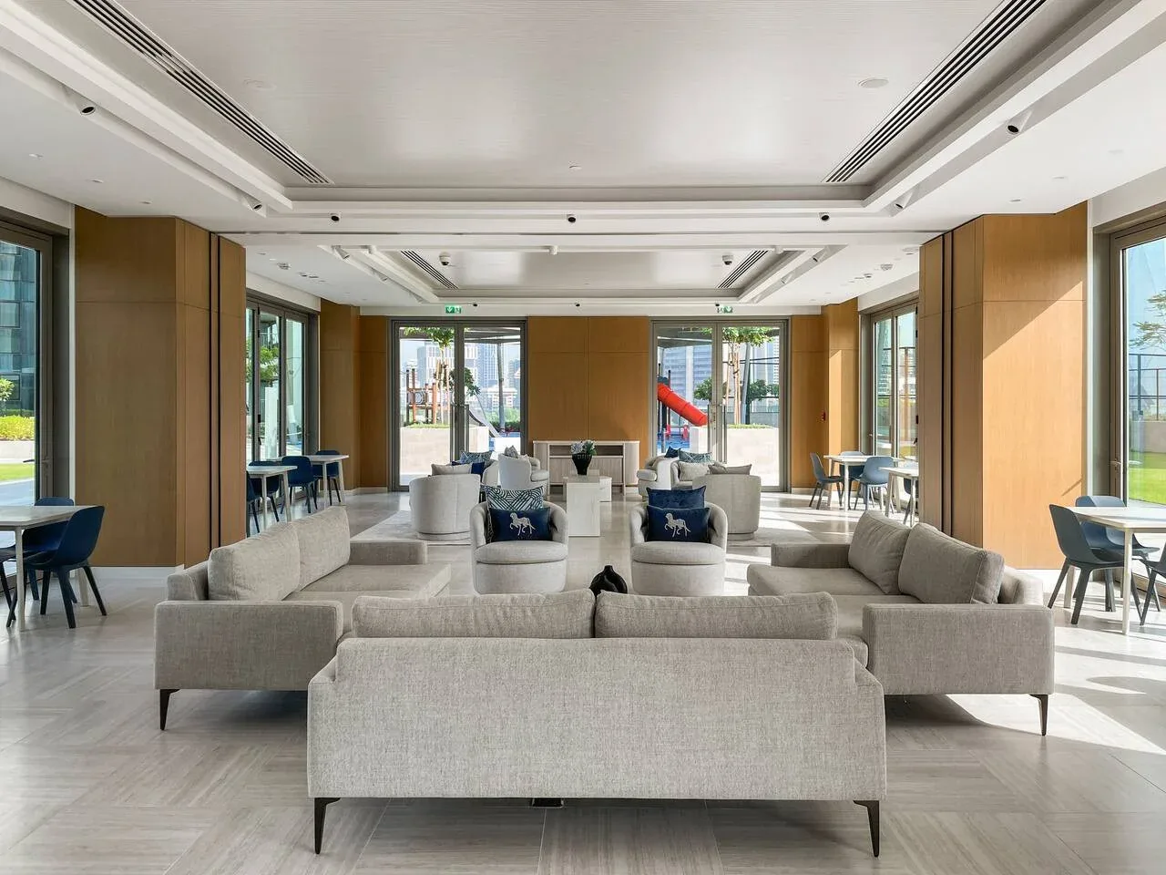 Un salón luminoso con asientos dispuestos y grandes ventanas.