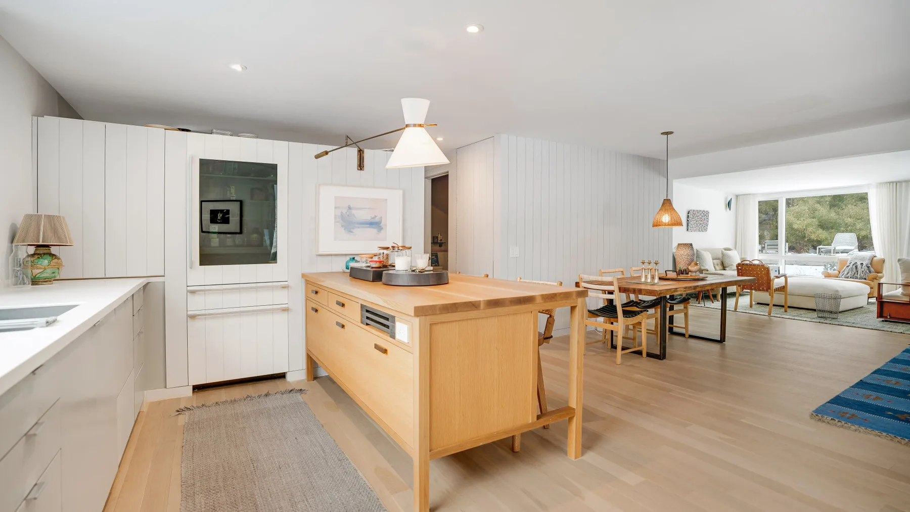 An open-plan kitchen and dining area with a central island and seating.