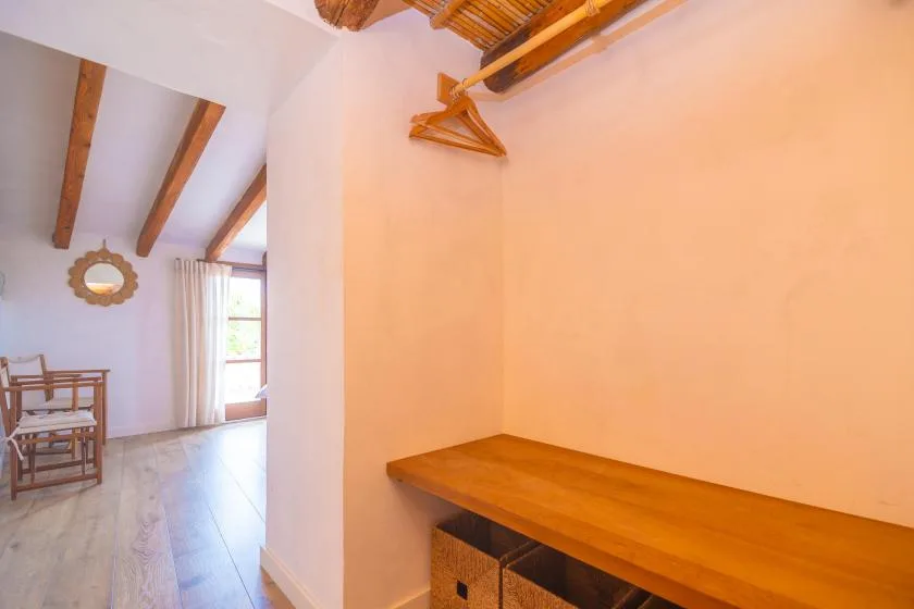 A bright room with a long wooden counter and a small dining area by the window.