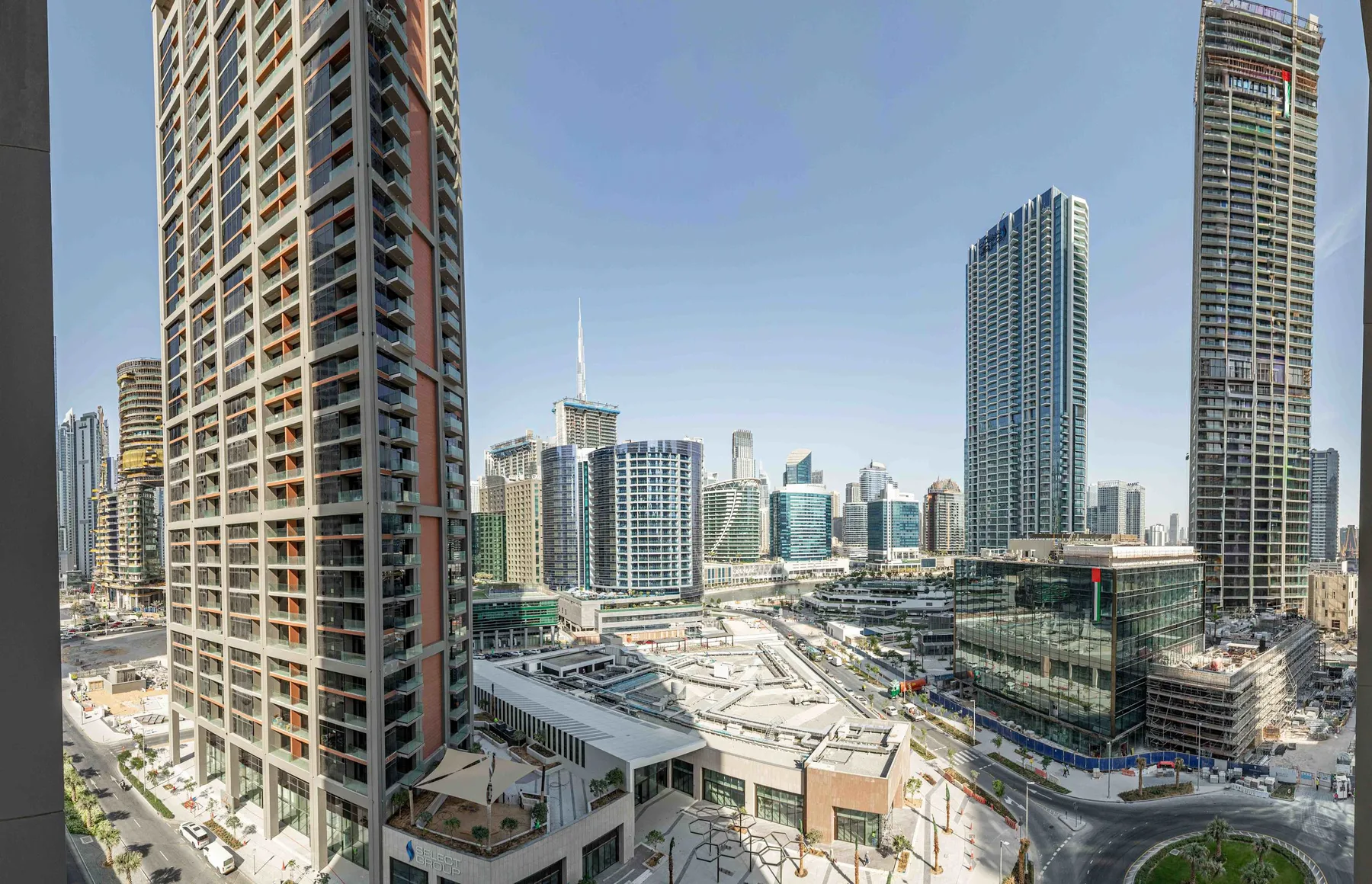 A city skyline of high-rise buildings surrounding a large construction site.