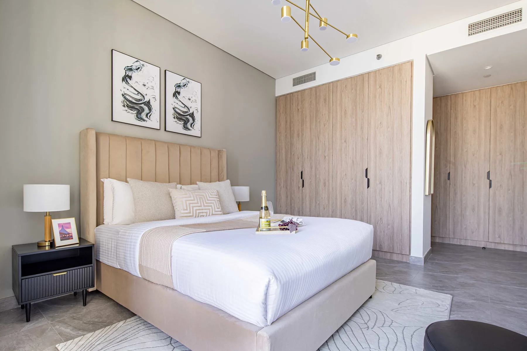 A bedroom with a neatly made bed and built-in wardrobes.