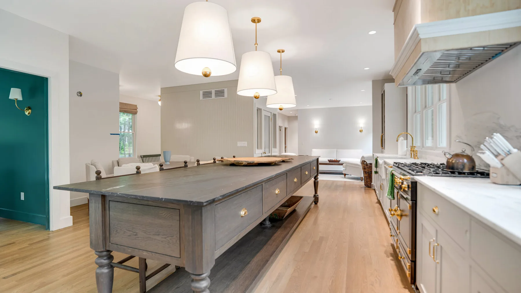 Una cocina amplia con una gran isla central y gabinetes blancos.