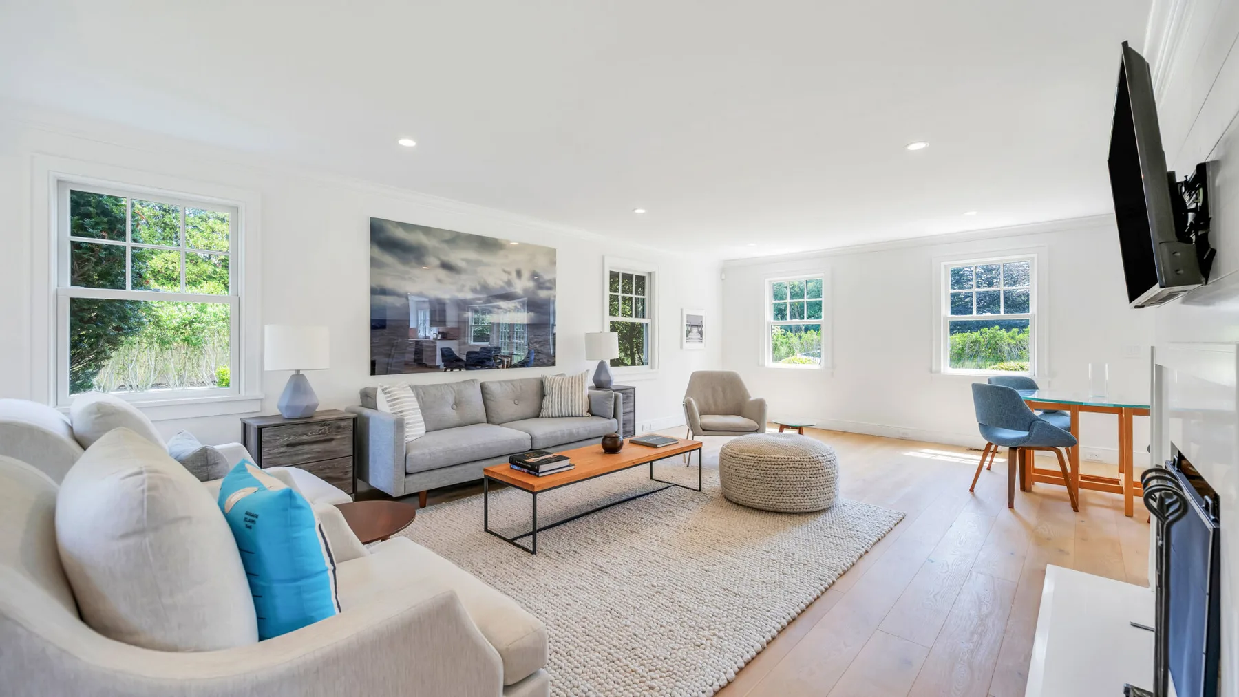A bright living room with seating arranged around a coffee table.