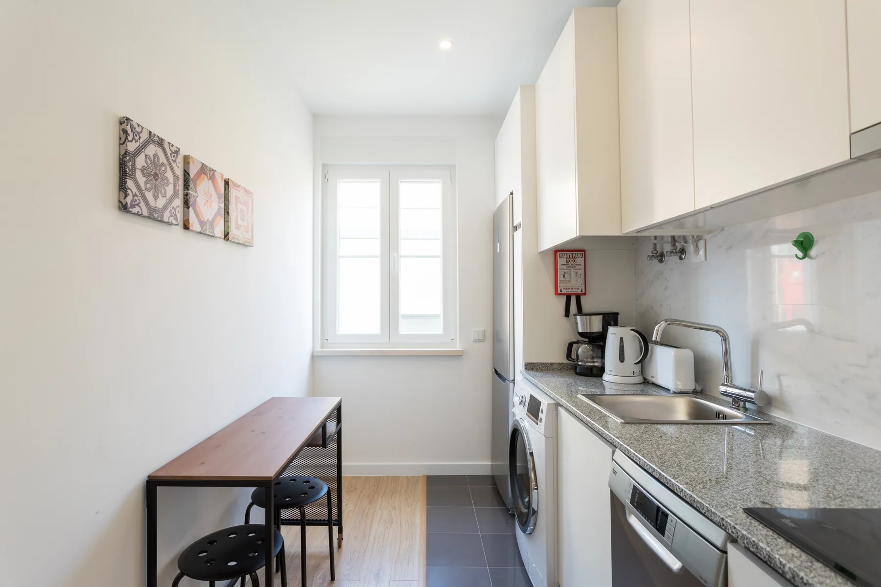 A compact kitchen with a counter, sink, and window.