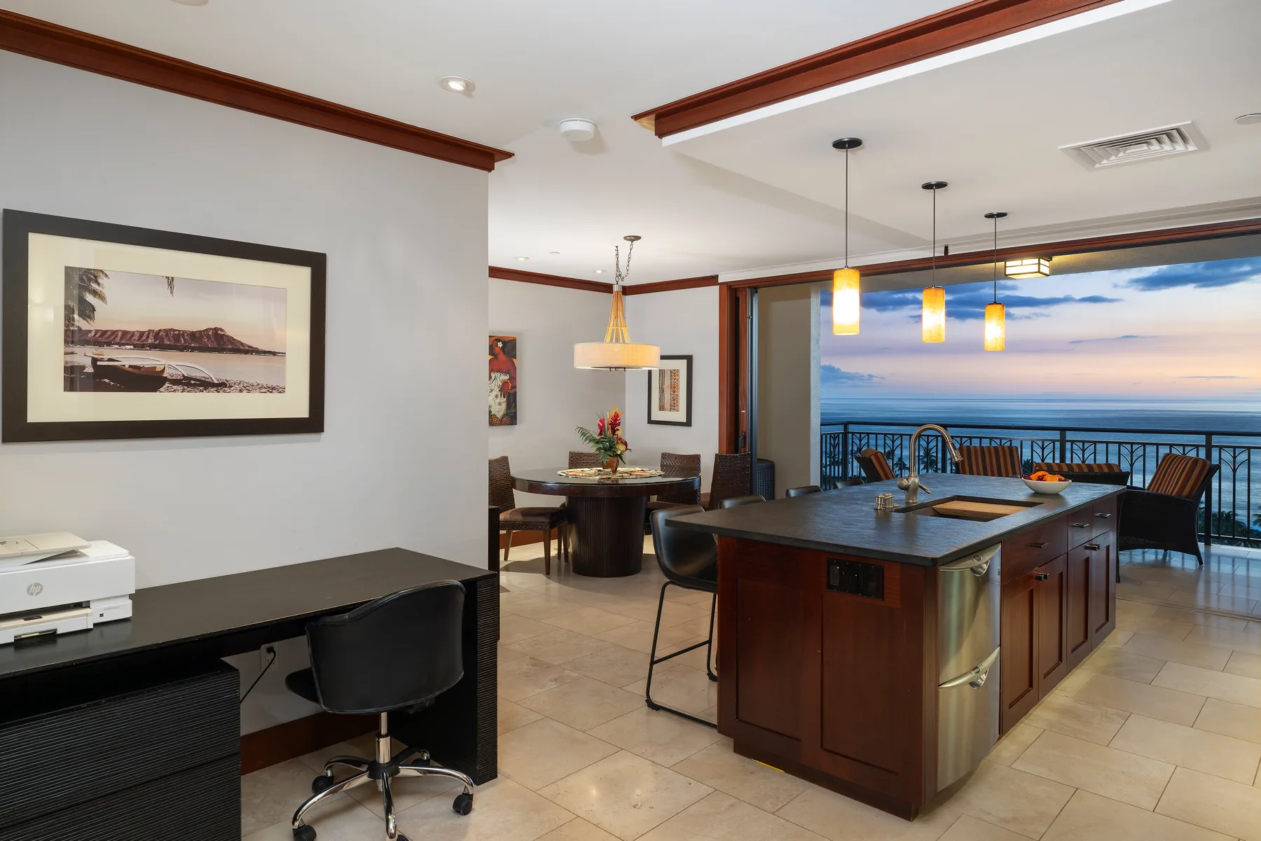 An open kitchen and dining area with pendant lights and a view of the water.