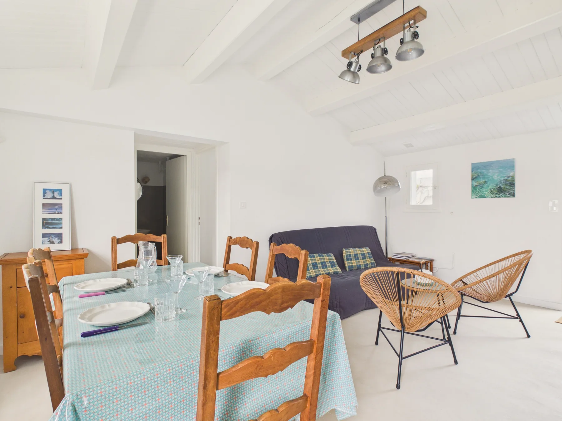 Dining and sitting area with a table and seating.