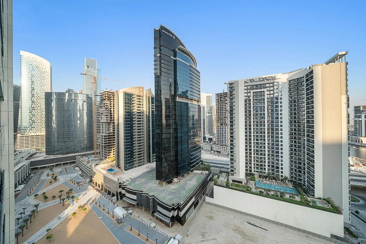 A cityscape of modern high-rise buildings under a clear blue sky.
