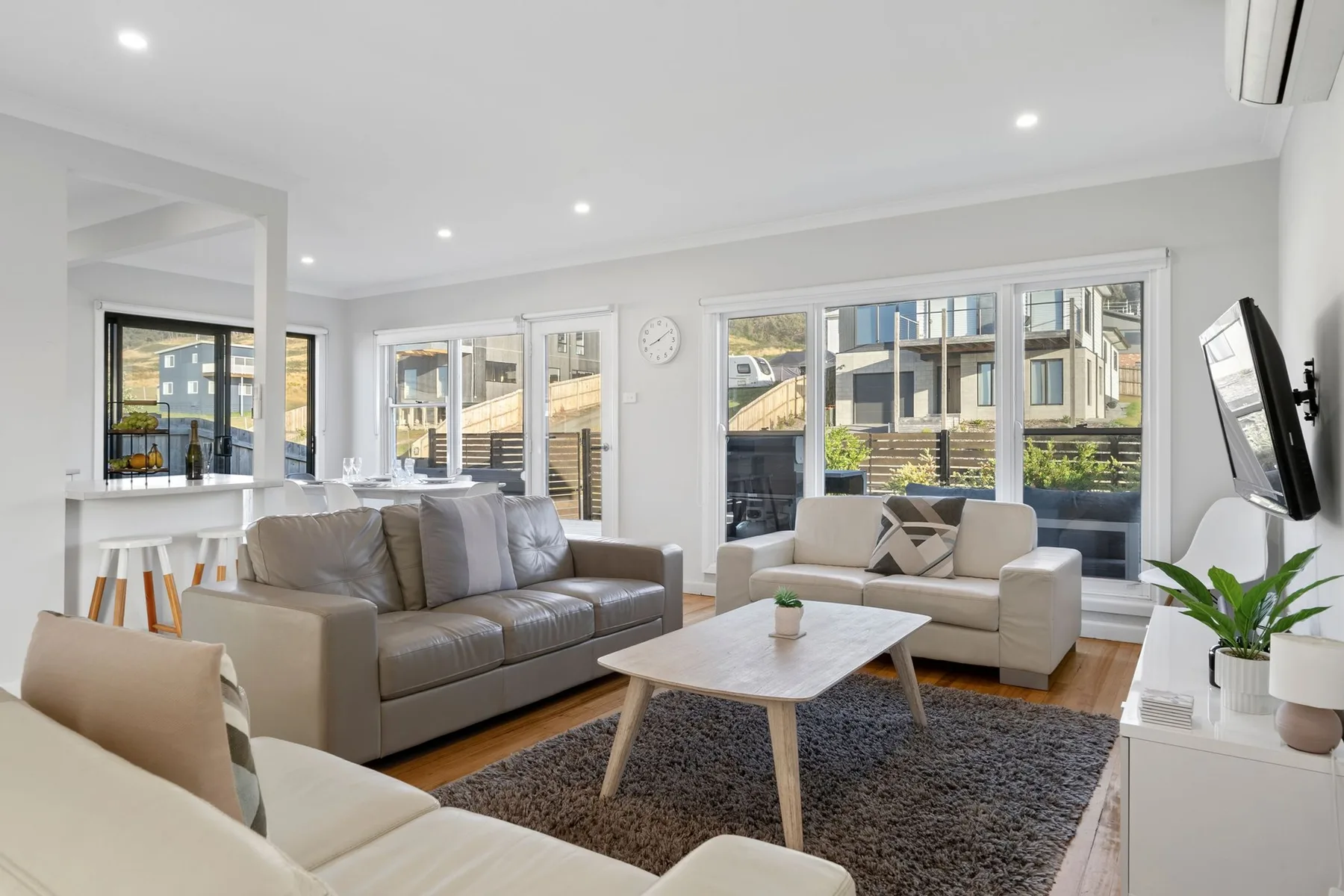 A bright living room with seating arranged around a coffee table.