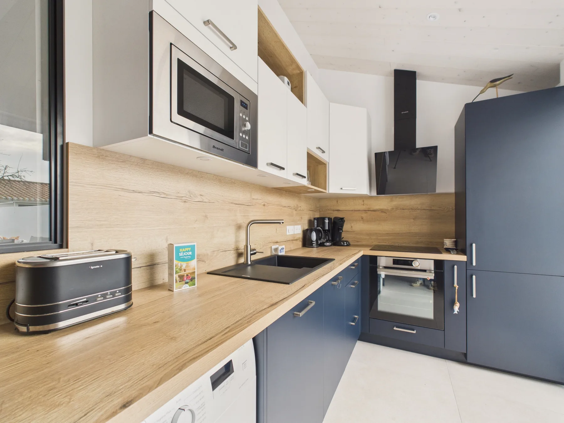 A modern kitchen with a countertop, sink, and built-in appliances.