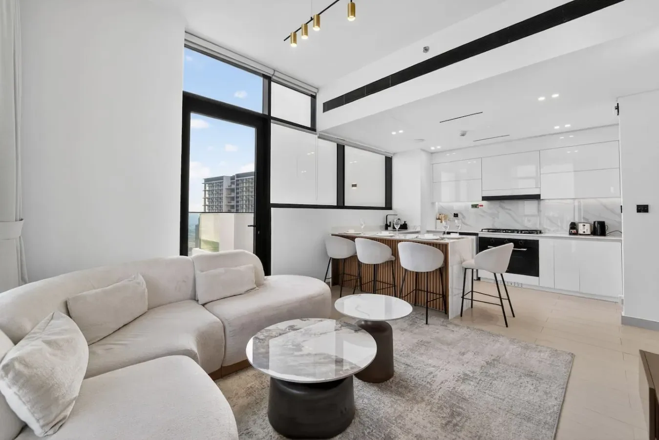 A bright open-plan living room and kitchen with seating and a central island.