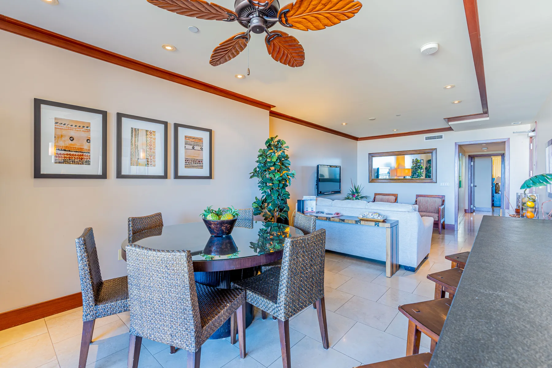 A bright living and dining area with a glass dining table and seating.
