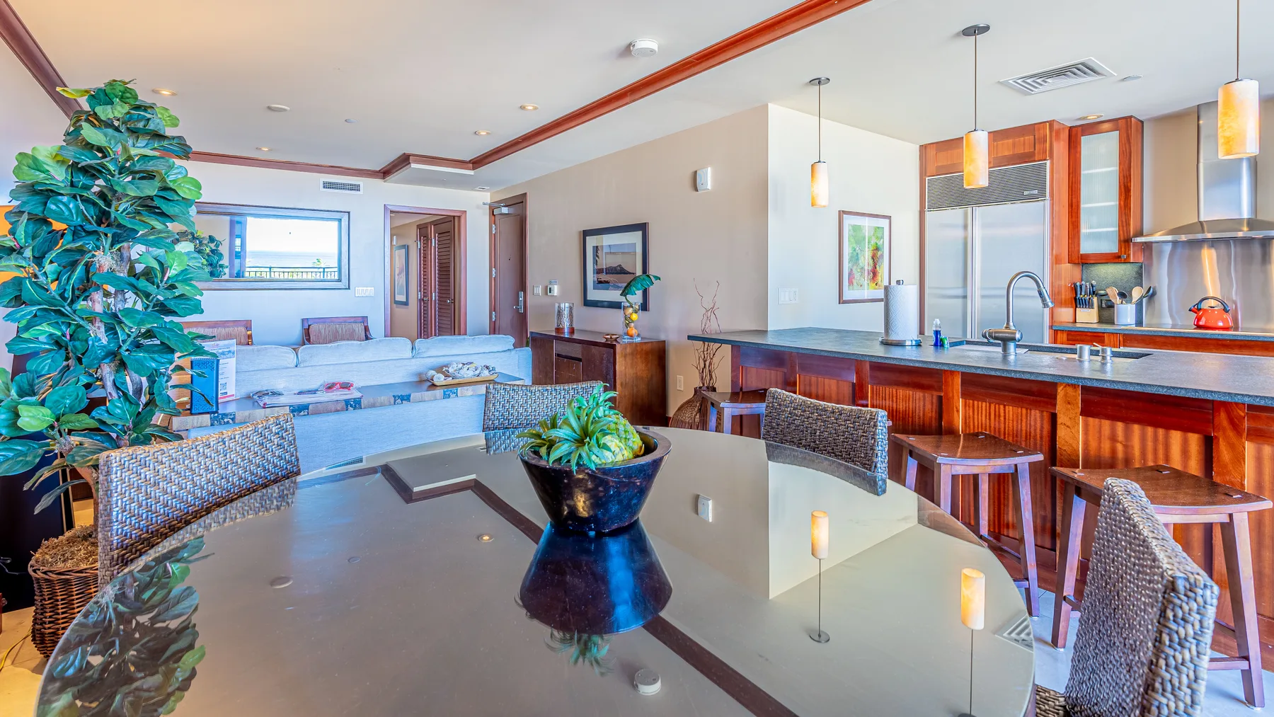 A spacious living area with a dining table and an open kitchen.