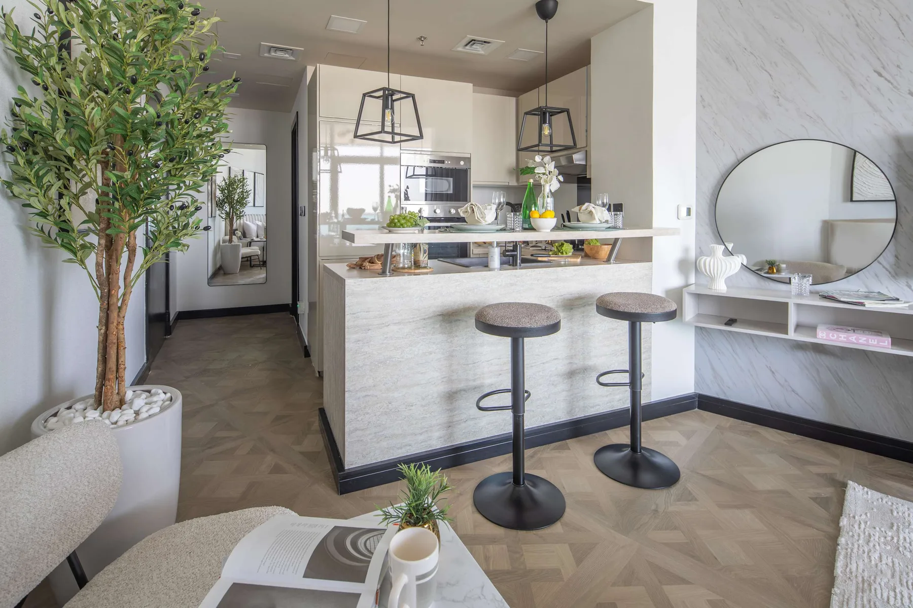 A bright modern kitchen and dining area features a long counter with bar seating.