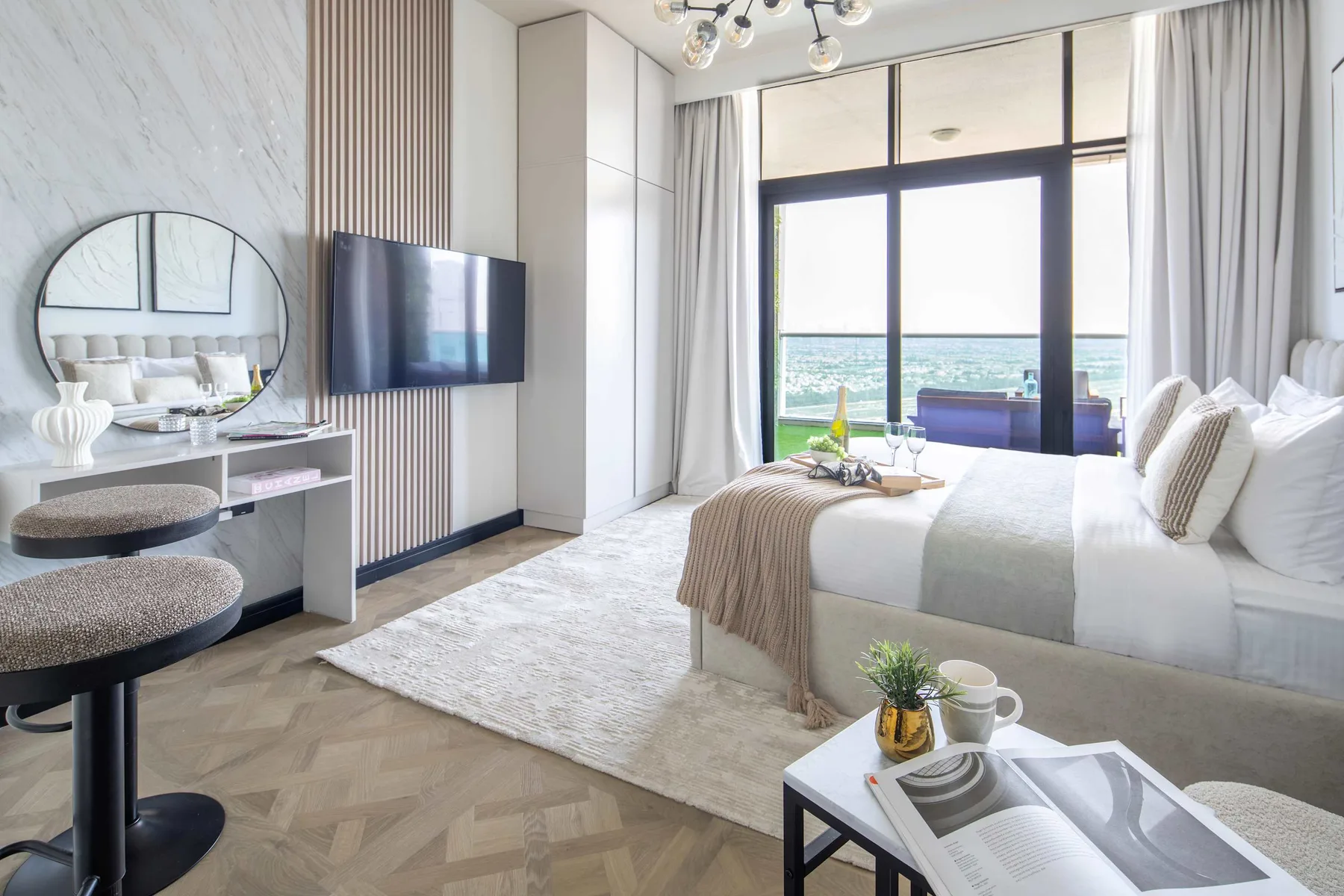 Un dormitorio luminoso con una cama grande junto a ventanales.
