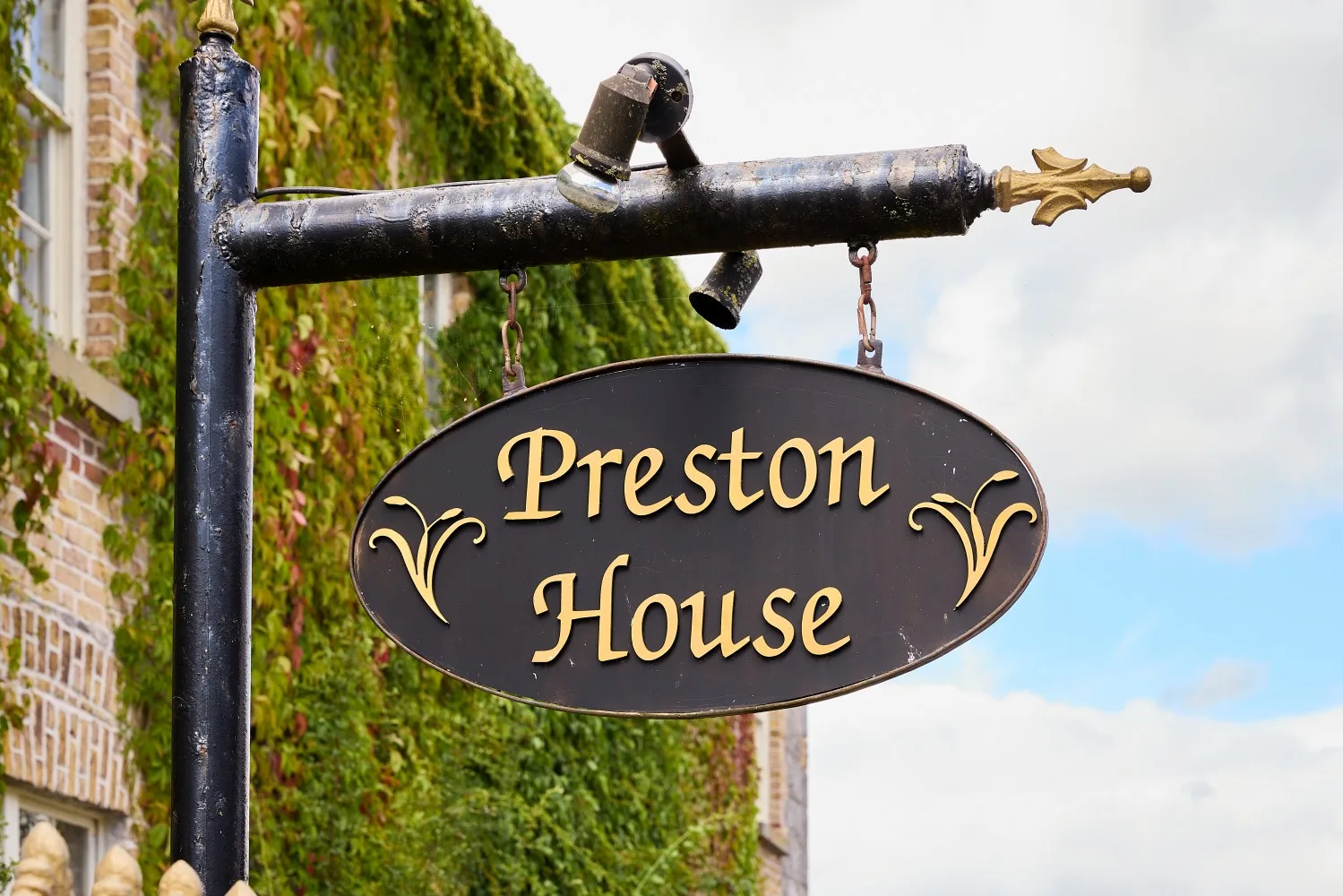 Preston House sign on an ivy-covered façade.