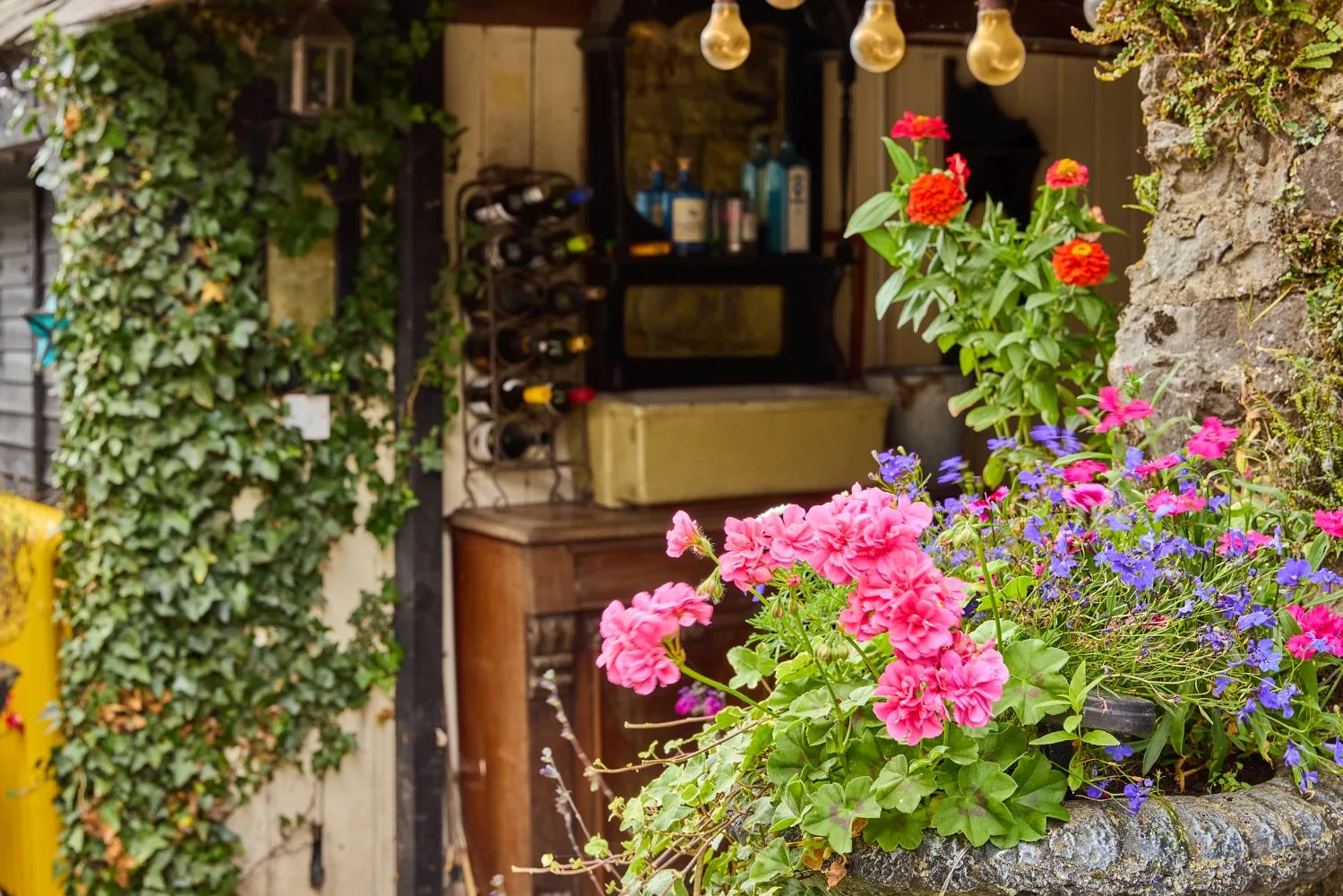 Flower planter beside the ivy-covered outdoor bar.