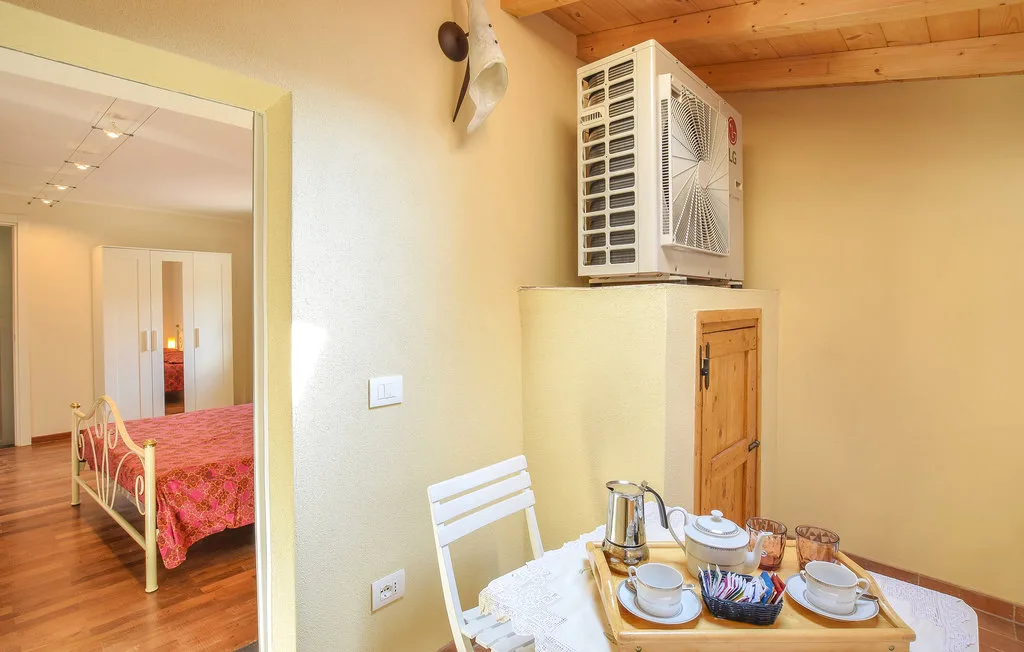 A bedroom and dining nook are shown, with a table set for a meal.