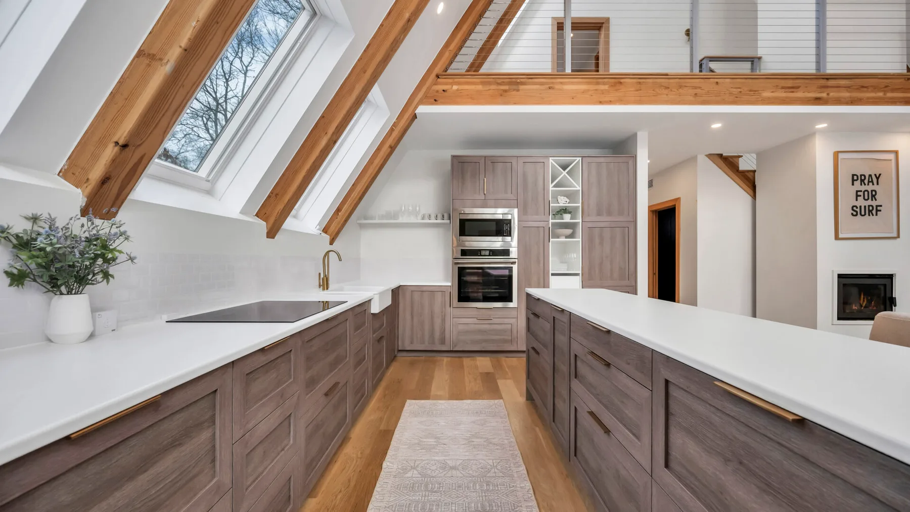 A bright kitchen with wood cabinetry and skylights.