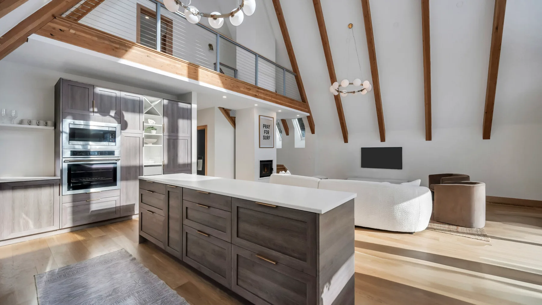 A bright open-plan kitchen and living area with a large central island.