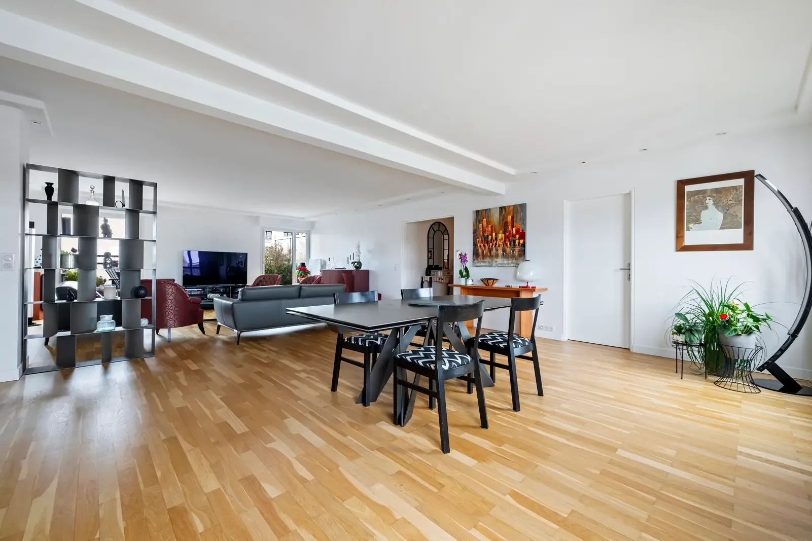 An open living and dining area with a dining table and seating.
