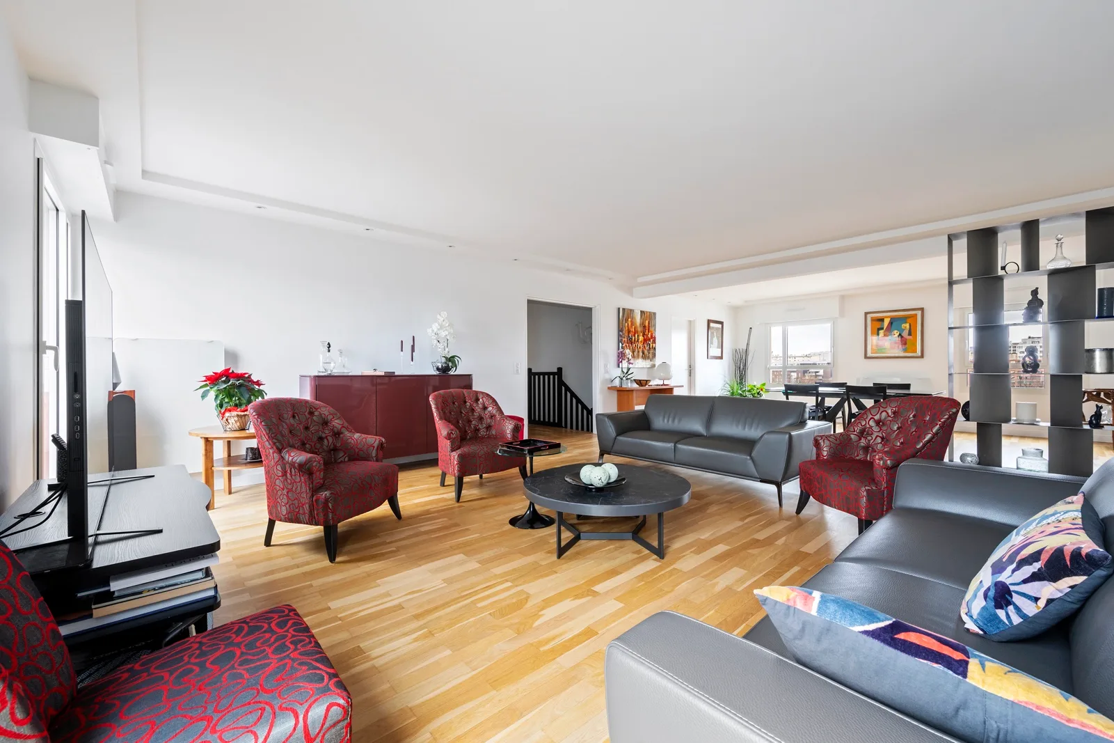 A bright living room with seating arranged around a coffee table.