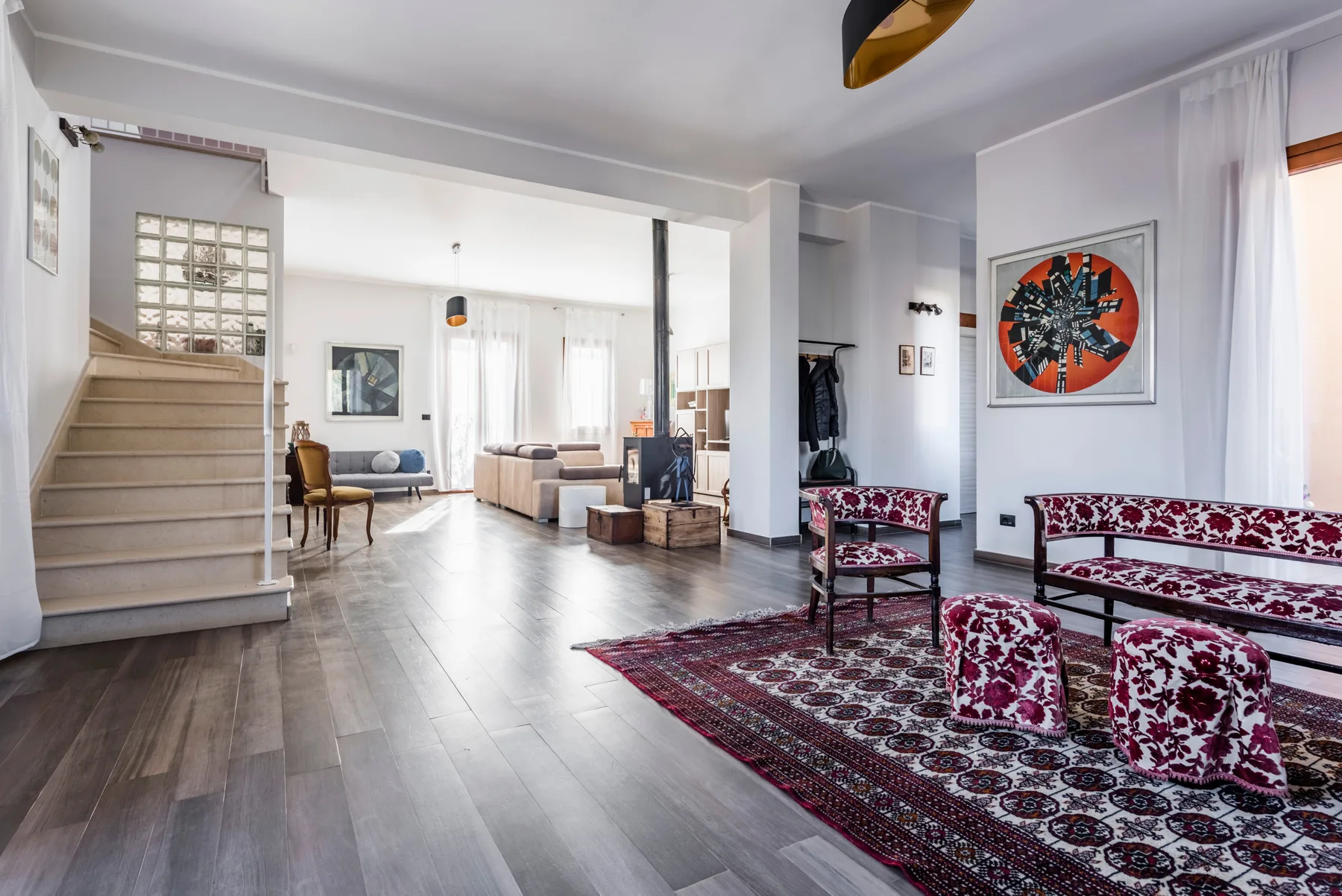 Una sala luminosa con asientos estampados y una alfombra.