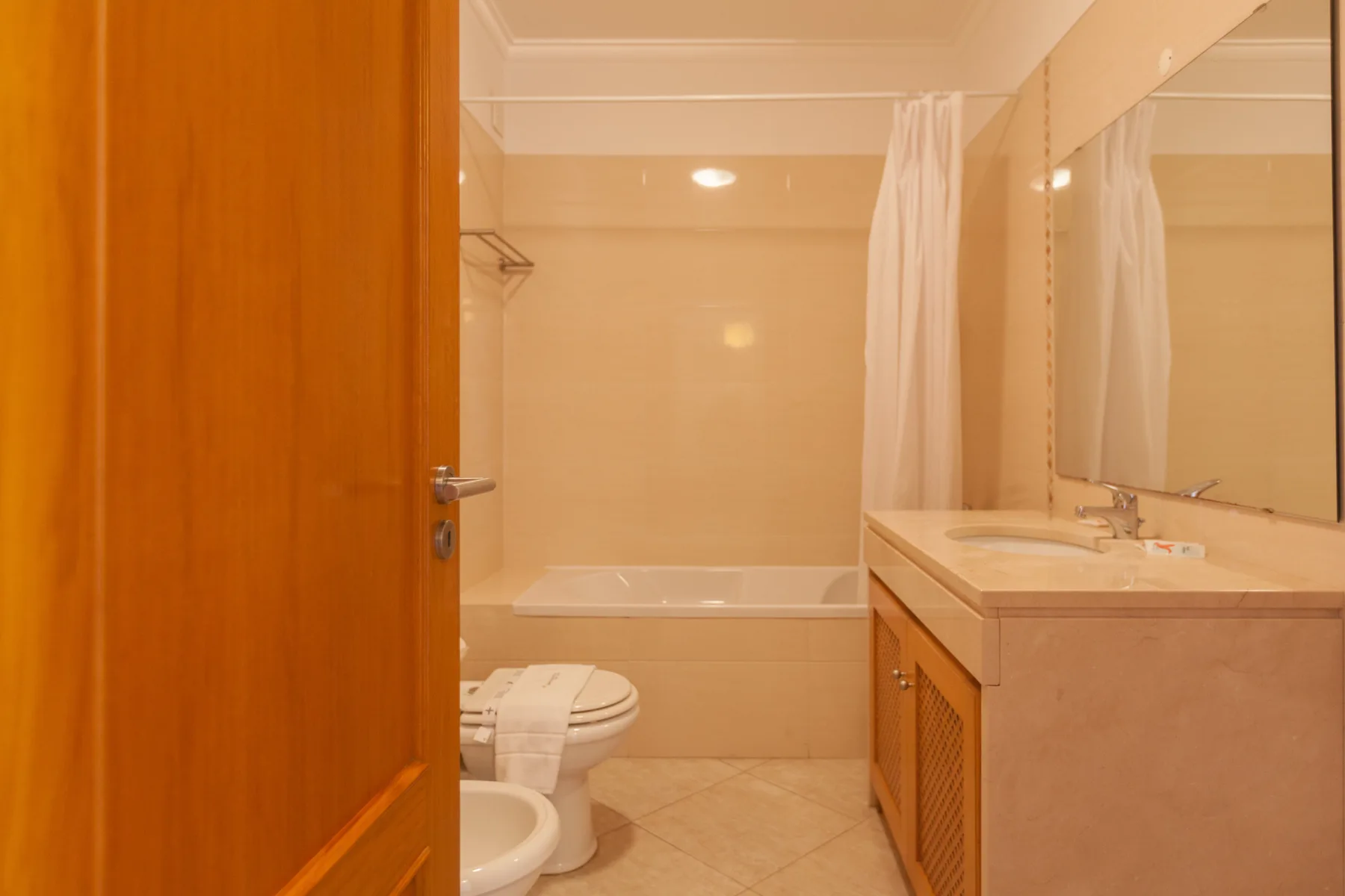 A bathroom with a bathtub, toilet, and sink.