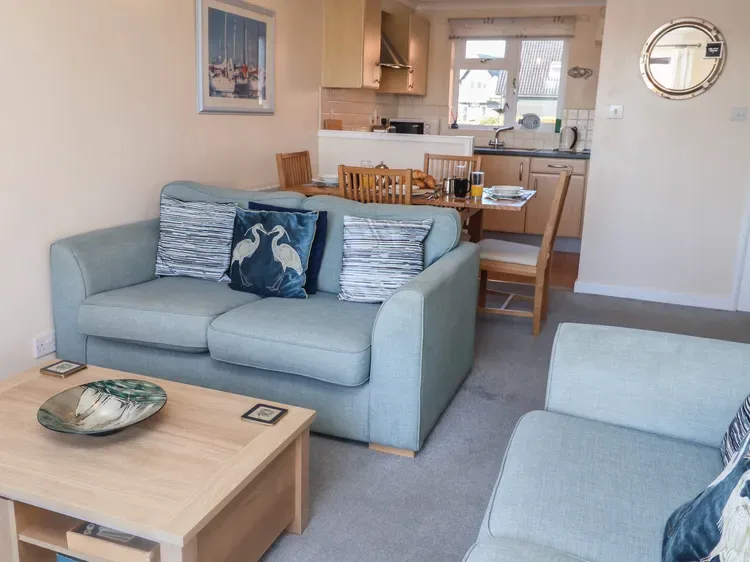 A living and dining area with seating, a coffee table, and a dining table.