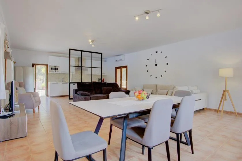 An open-plan living and dining area with a dining table and seating.